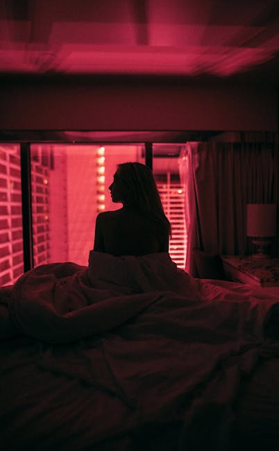 Woman in a calm meditative pose, bathed in soft, moody light